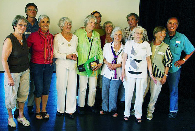 A group of people smile as the pose for a group photograph